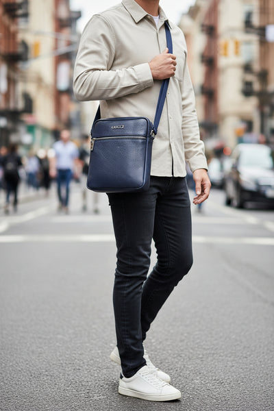 Blue Gucci handbag with a visible tag on a white background